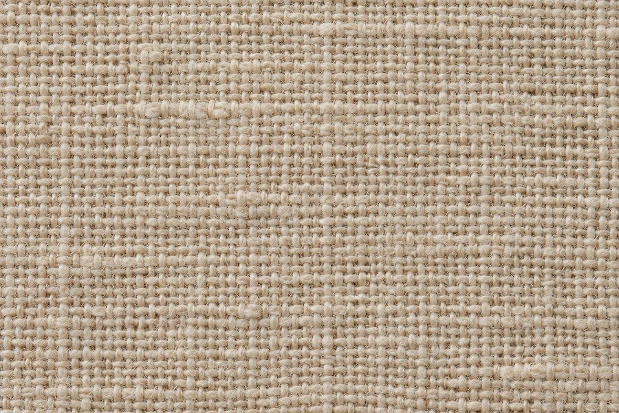 Natural beige linen canvas texture with tight woven weave, close-up fabric background with visible slubs