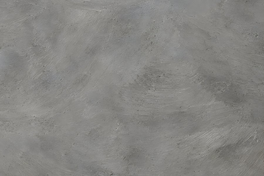 Smooth grey concrete wall texture with swirling trowel marks for an industrial minimal background