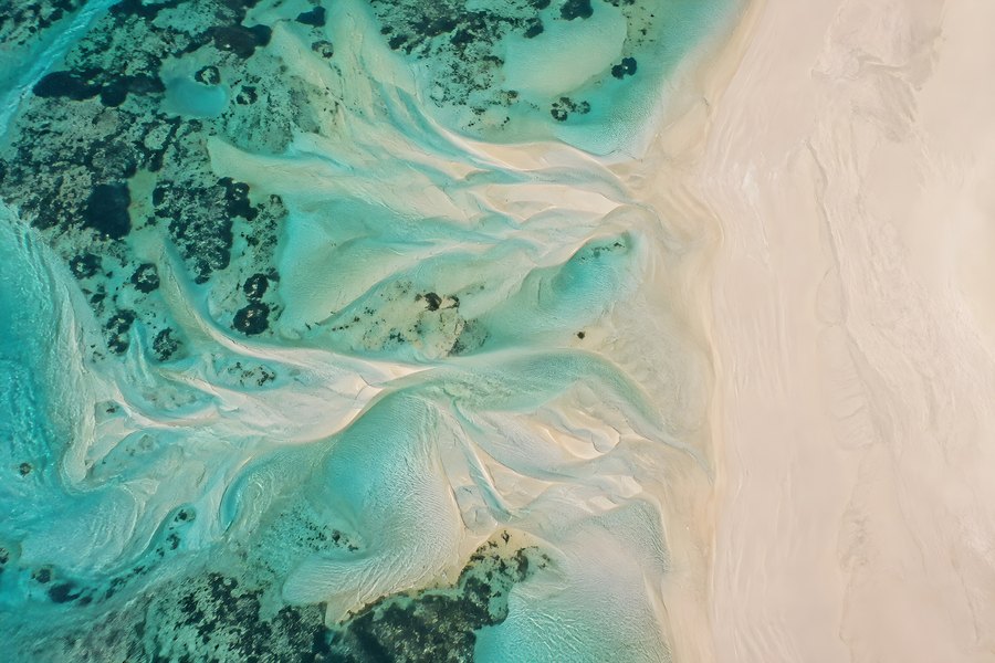 Aerial View of Empty Coastline with Turquoise Tidal Channels Winding Through a White Sandbar
